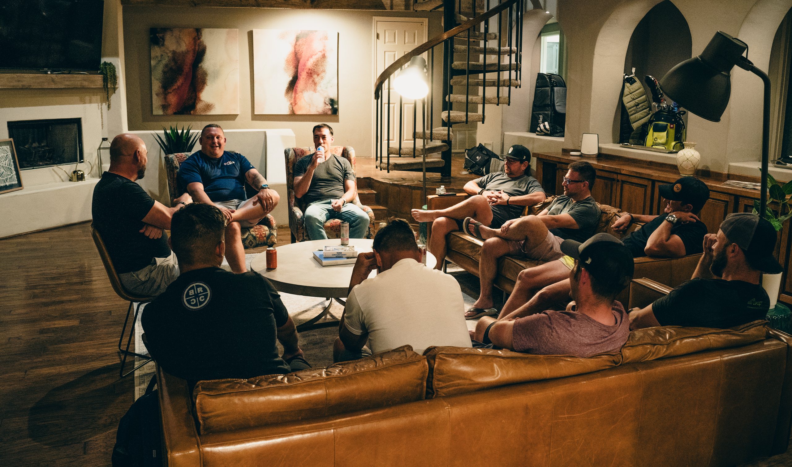 Shawn Feurer and a mastermind group in conversation around a living room